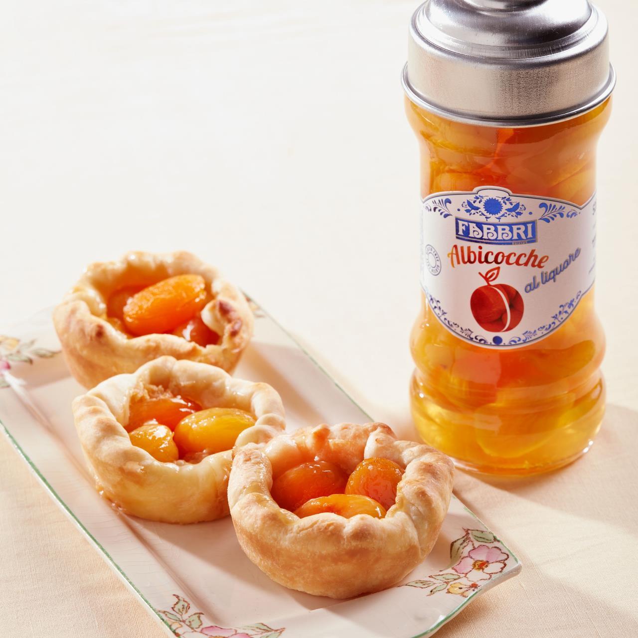 Puff pastry tartlets with custard and apricots in Fabbri liqueur